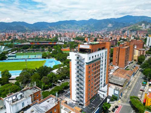 an overhead view of a city with a tall building at Tequendama Hotel Medellín - Estadio in Medellín