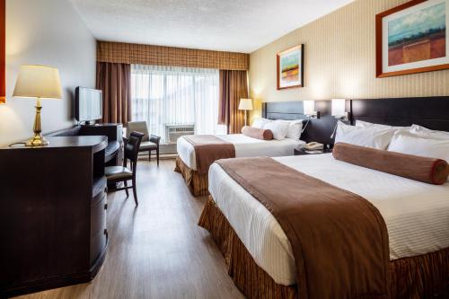 Postel nebo postele na pokoji v ubytování Auberge Royal Versailles