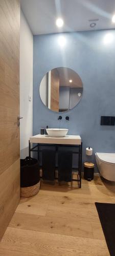 a bathroom with a sink and a toilet and a mirror at Retiro Studio 34 in Guimarães