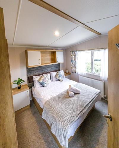 a bedroom with a bed with a towel on it at 2Bed Whitley Bay Home - Free Parking, Close to beach & St Mary's Lighthouse in Whitley Bay