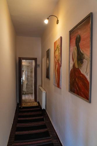 a hallway with three paintings on the walls at Villa Norma in Órma