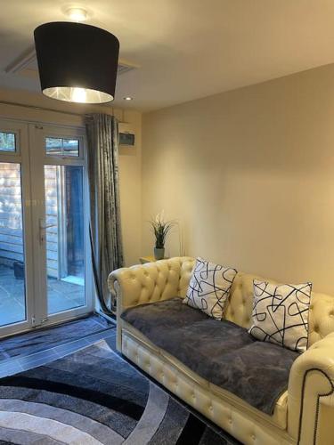 a living room with a couch and a window at Flat 3 Meadow View Cozy Getaway in Hurst