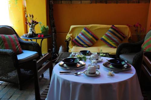 a table with plates of food on top of it at Palmeiras Guest House Maputo in Maputo