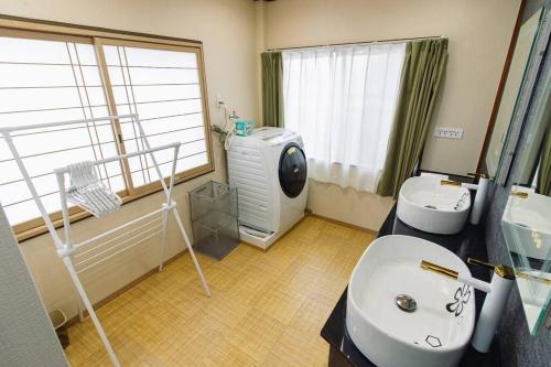 a bathroom with a sink toilet and a washing machine at QiQi House Tokyo Hirai Villa 2Bath3WCs 4min Station 24min to Akihabara in Tokyo