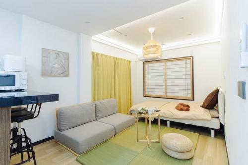 a living room with a couch and a bed at QiQi House Tokyo Hirai Villa 2Bath3WCs 4min Station 24min to Akihabara in Tokyo