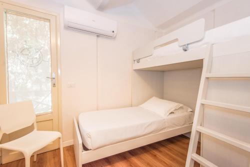 Ένα ή περισσότερα κρεβάτια σε δωμάτιο στο Resort Riva Degli Etruschi