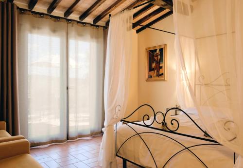 a bedroom with a bed and a window at Agriturismo San Sano in Gaiole in Chianti