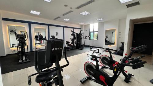 a gym with treadmills and exercise bikes in it at Tequendama Hotel Medellín - Estadio in Medellín