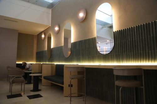 a bar with a large letter k on the wall at Tequendama Hotel Medellín - Estadio in Medellín