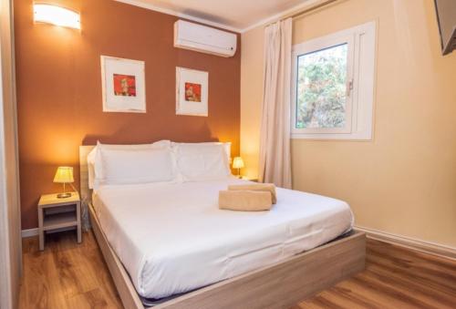 Ένα ή περισσότερα κρεβάτια σε δωμάτιο στο Resort Riva Degli Etruschi