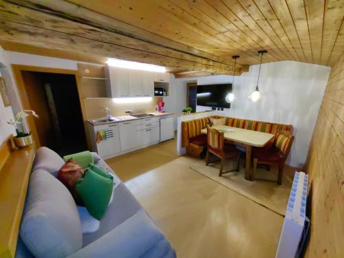 a living room and kitchen with a couch and a table at Haus Groder in Rauris