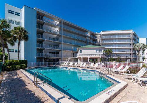 a swimming pool in front of a apartment building at Renovated Condo Offering Free Beach Access!! in Marco Island