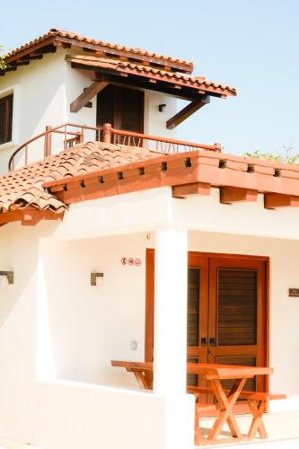 a house with a porch and a deck at Refugio de piedra - Troncones in Troncones