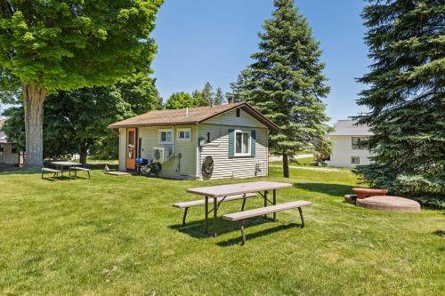 a picnic table in front of a tiny house at Chippewa Bluffs Resort Combined 3BR 3BA Cabins in Barryton