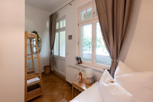 a bedroom with a bed and a window at Gästehaus am Winckel in Stendal