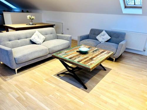 a living room with a couch and a coffee table at 1 Old Sefter School House in Bognor Regis