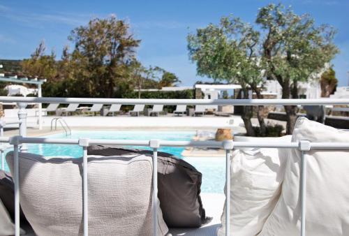 a balcony with pillows and a swimming pool at Verina Terra in Platis Gialos