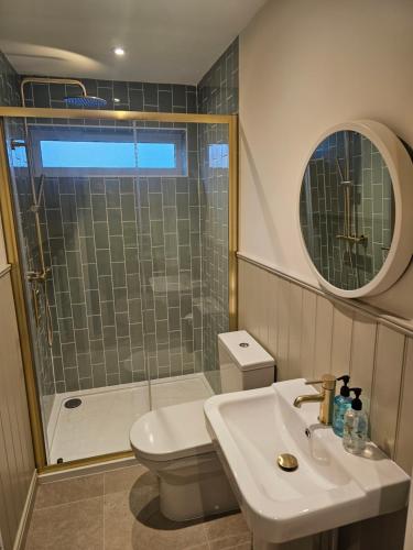 a bathroom with a sink and a toilet and a shower at Newditch Farm - BRS Airport in Bristol