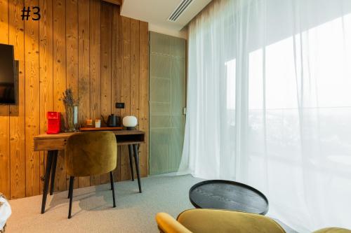a room with a table and chairs and a window at The Pines Bucegi Lodge in Bran