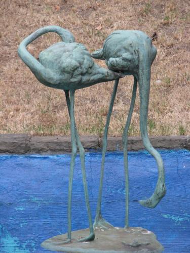 two statues of birds standing in the water at Hotel Villa im Park in Düsseldorf