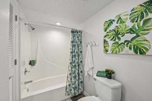 a bathroom with a toilet and a shower at Sandpiper Beacon Beach Resort in Panama City Beach
