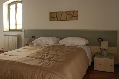 a bedroom with a large bed with two pillows at Villa Carlotta in Nuxis