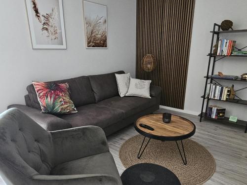 a living room with a couch and a coffee table at Ferienwohnung Nationalpark in Nideggen