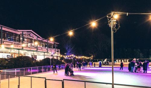 a group of people skating on an ice rink at night at Brocks in Bath
