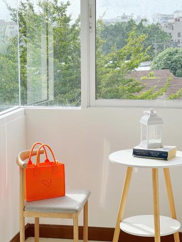 an orange bag sitting on a table next to a table at Lanting House Phuket in Patong Beach