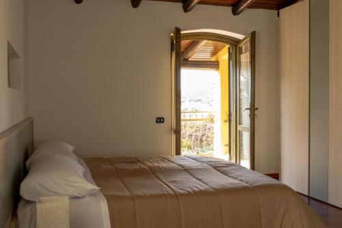 a bedroom with a bed and an open door at Villa Carlotta in Nuxis