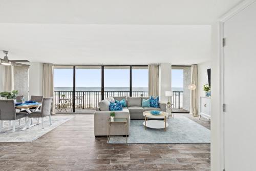 a living room with a couch and a table at Sandpiper Beacon Beach Resort in Panama City Beach