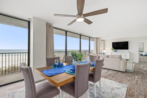 a dining room with a table and chairs and a couch at Sandpiper Beacon Beach Resort in Panama City Beach