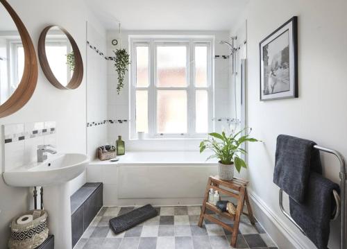 a bathroom with a white tub and a sink at Dudley-Spacious Exec 2 bed - Long stay - Parking! in Dudley