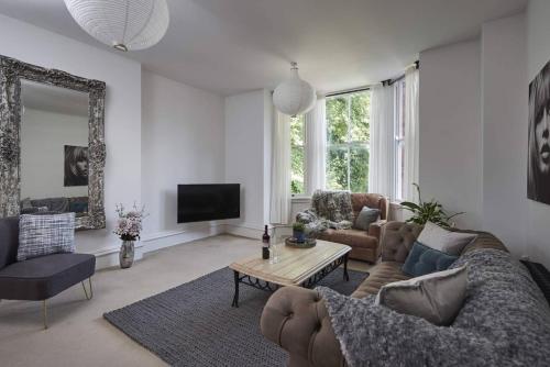 a living room with a couch and a table at Dudley-Spacious Exec 2 bed - Long stay - Parking! in Dudley