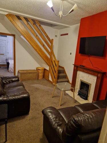 a living room with a couch and a fireplace at Balfour House in Leicester