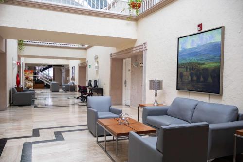 a lobby with couches and a table in a building at Best Western PLUS Monterrey Colón in Monterrey