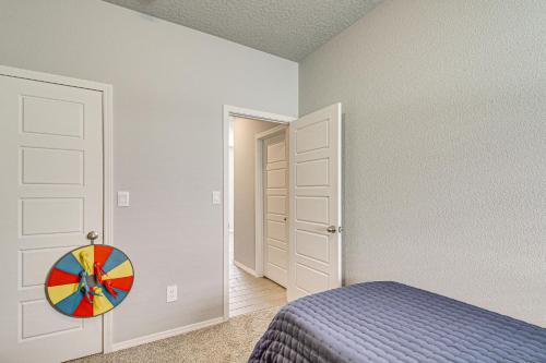 a bedroom with a bed and a colorful wheel on the door at Family-Friendly Rio Rancho Home Near Old Town in Rio Rancho