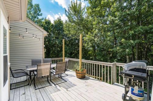 a deck with a table and chairs and a grill at Weekend Retreat Hot Tub Game Room Putt Putt in Lancaster