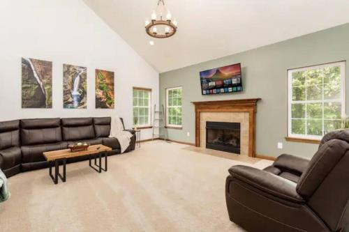a living room with a couch and a fireplace at Weekend Retreat Hot Tub Game Room Putt Putt in Lancaster