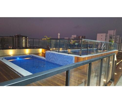 a swimming pool on the roof of a building at Palazzo di Milano in Ilhéus