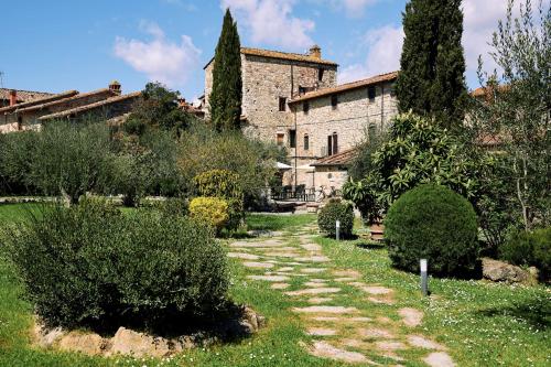 a stone path in front of a large building at Agriturismo San Sano in Gaiole in Chianti