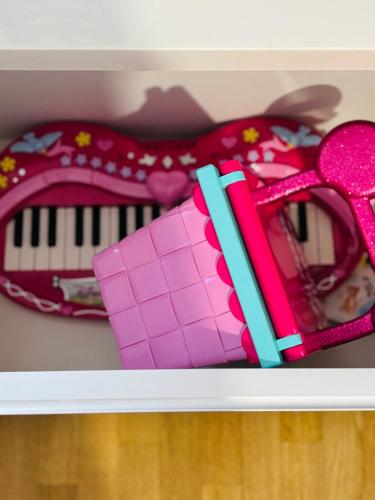 a shelf with a toy piano and a toy keyboard at THE ENCHANTED HOUSE ( 15 min walk to Disney) in Serris