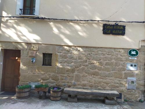 a stone building with a bench in front of it at Casa la ilera in Casalarreina