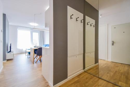 a living room with a glass door and a table at Apartman COMO, private parking free in Košice