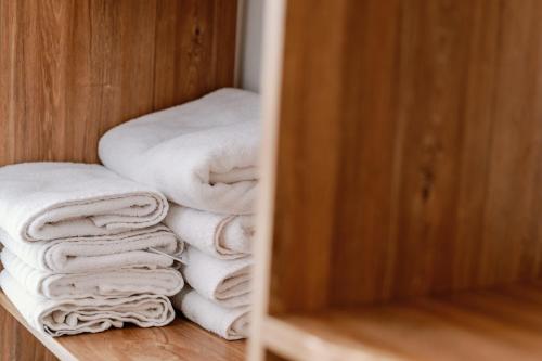 a pile of towels are stacked in a closet at Endless View loft in Mesimvría