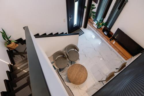 a group of chairs in a room with a table at Endless View loft in Mesimvría