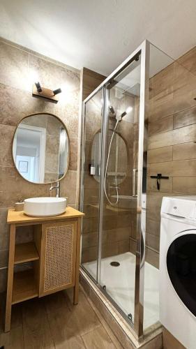 une salle de bain avec une douche, un lavabo et un miroir dans l'établissement Le chic à la Caladoise avec balcon, à Gleizé