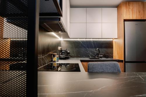 a kitchen with white cabinets and a counter top at Endless View loft in Mesimvría