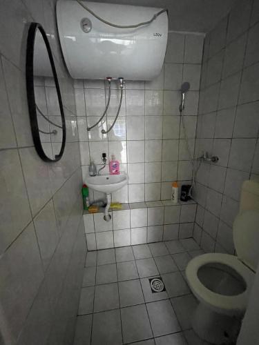 a bathroom with a sink and a toilet at Comfort Studio Prishtina City Centre in Pristina