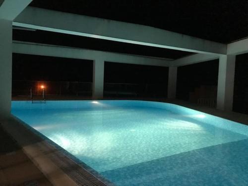 a large swimming pool lit up at night at SUN Studio - Apartamentos Vista do Atlântico in Capelo